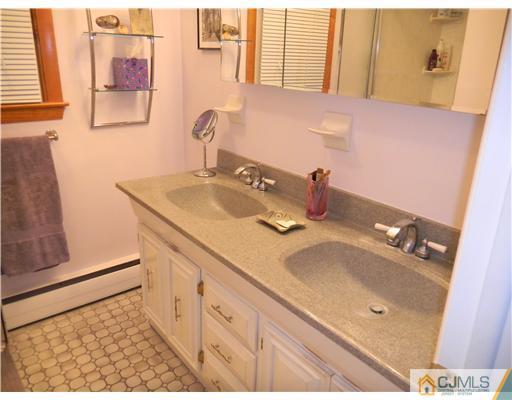 11 Devon Road Edison, NJ 08820 - Photo 19 of 23 a bathroom with a sink and a mirror