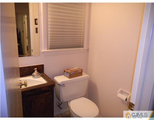 11 Devon Road Edison, NJ 08820 - Photo 21 of 23 a bathroom with a sink and a toilet
