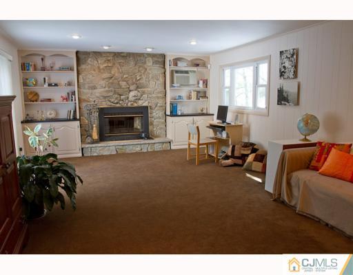 11 Devon Road Edison, NJ 08820 - Photo 4 of 23 a living room with furniture and a fireplace