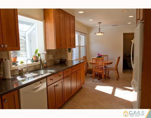 11 Devon Road Edison, NJ 08820 - Photo 5 of 23 a open kitchen with stainless steel appliances granite countertop a refrigerator and a sink