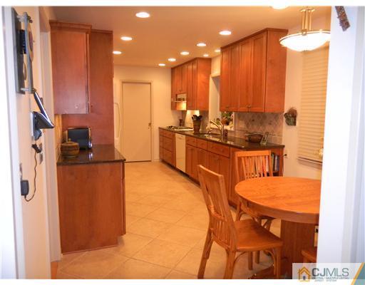 11 Devon Road Edison, NJ 08820 - Photo 6 of 23 a kitchen with stainless steel appliances kitchen island granite countertop a refrigerator and a stove