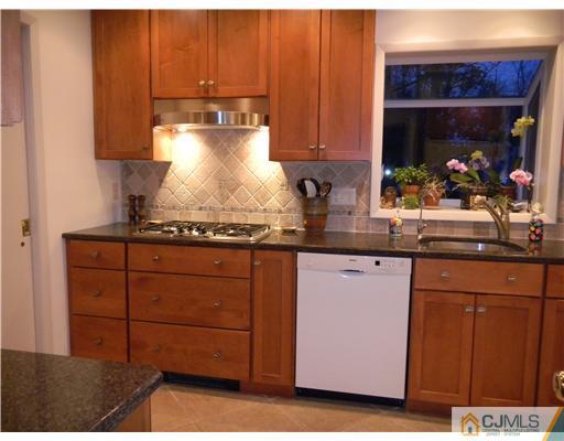 11 Devon Road Edison, NJ 08820 - Photo 8 of 23 a kitchen with sink cabinets and a fireplace