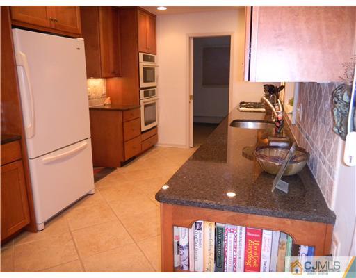 11 Devon Road Edison, NJ 08820 - Photo 10 of 23 a kitchen with stainless steel appliances granite countertop a refrigerator and a stove