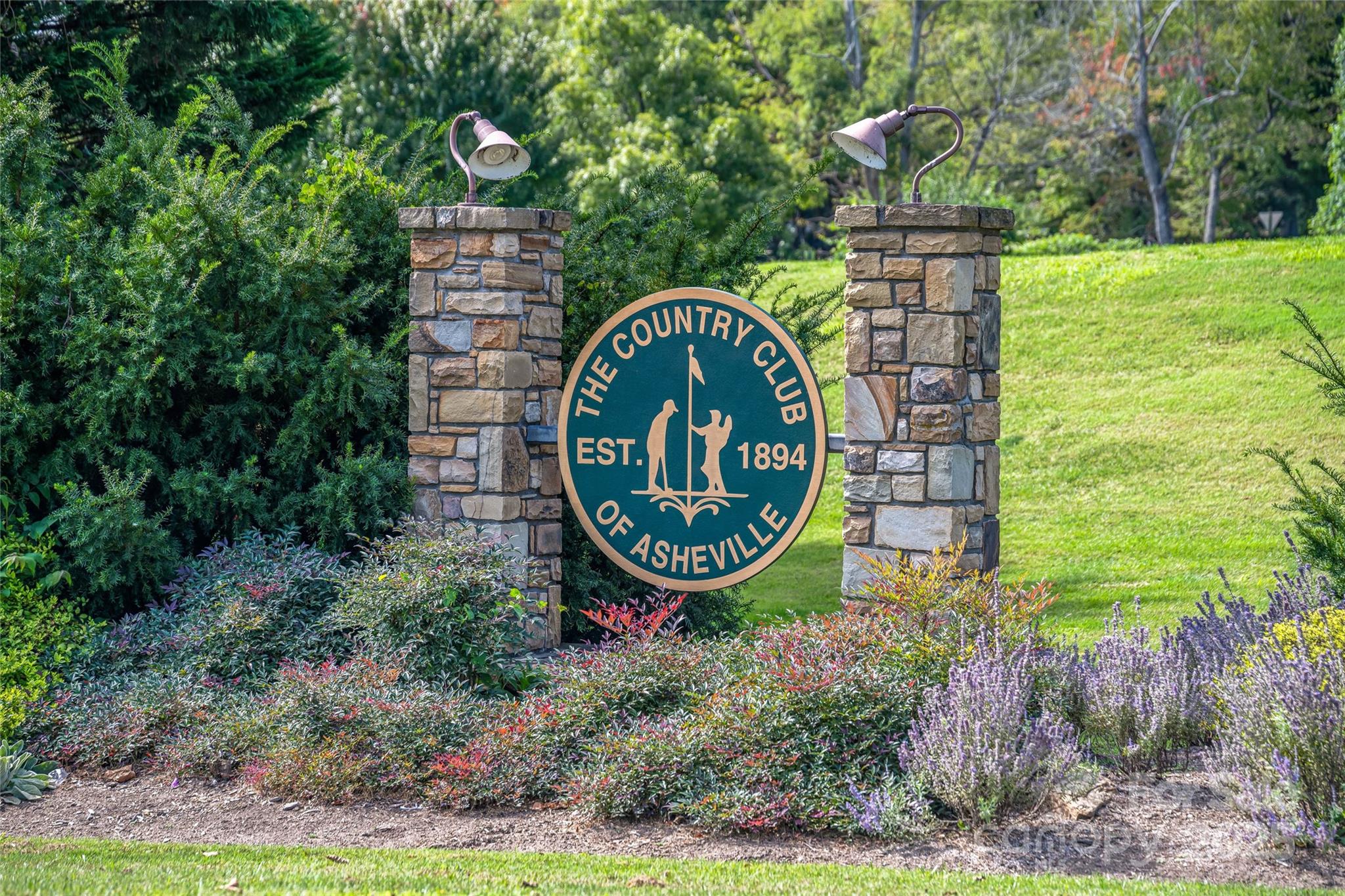 33 Grovepoint Way Asheville, NC 28804 - Photo 13 of 32 a front view of a house with garden space and trees all around