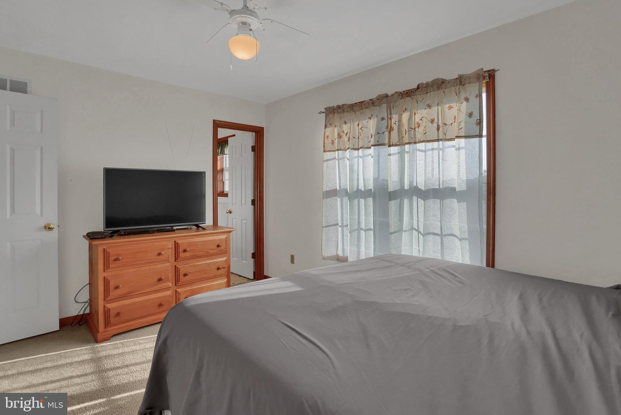 6124 Gregory Road Spring Grove, PA 17362 - Photo 14 of 43 a bedroom with a bed and a flat screen tv