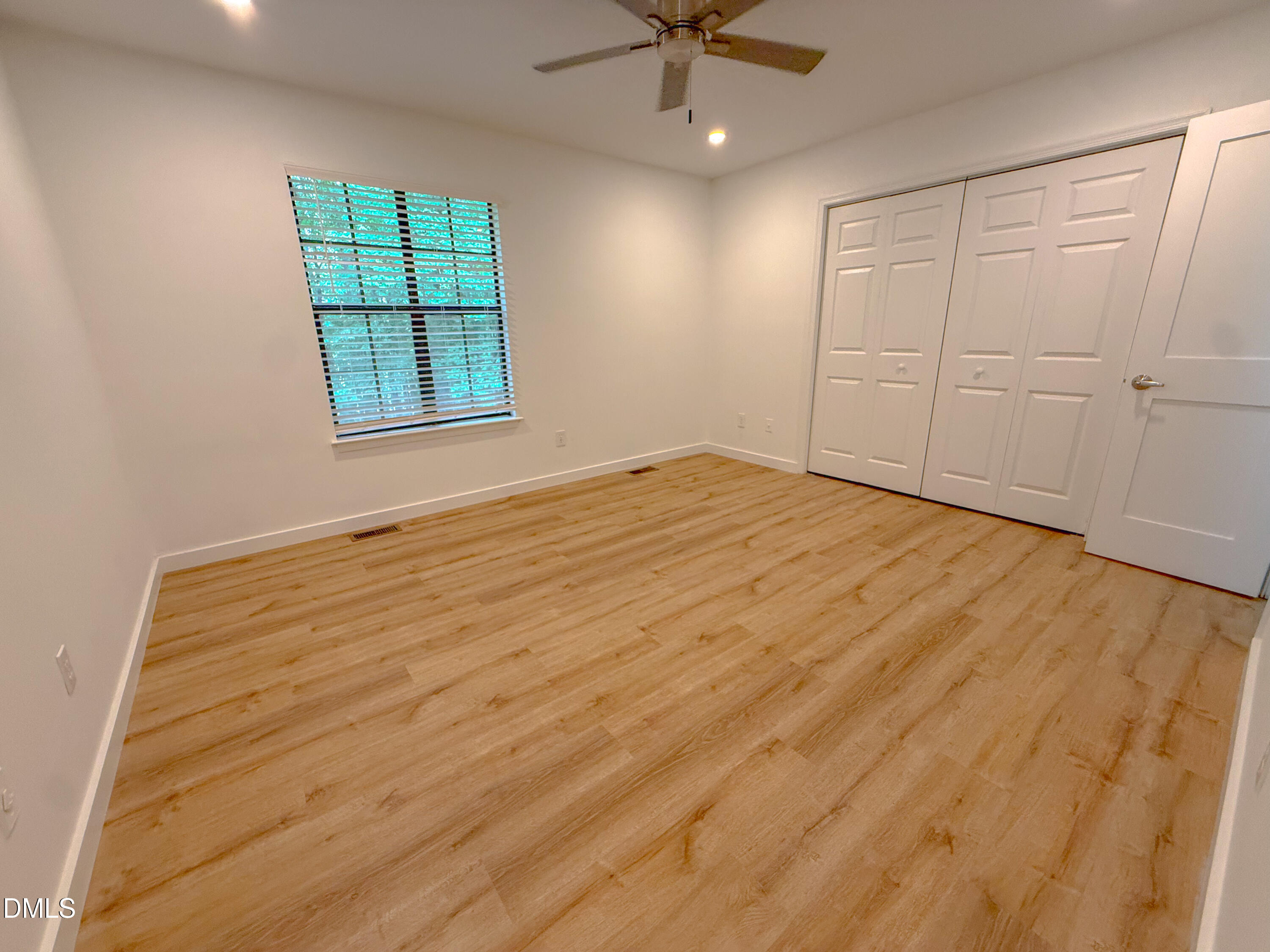 4247 The Oaks Drive Raleigh, NC 27606 - Photo 19 of 21 an empty room with windows and fan