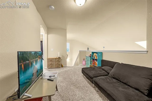 a living room with couches and a flat screen tv