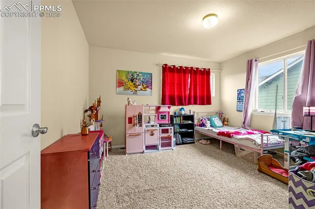 a bedroom with furniture and a window