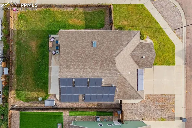 an aerial view of a house with a yard