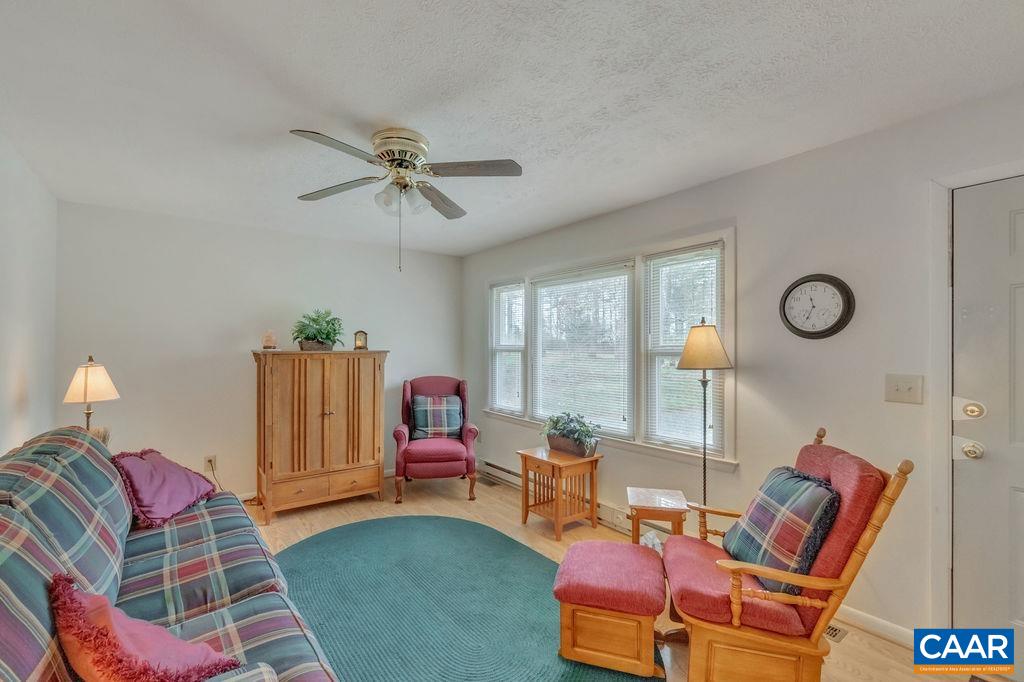 232 Rising Sun Road Palmyra, VA 22963 - Photo 8 of 31 a living room with furniture a lamp and a large window