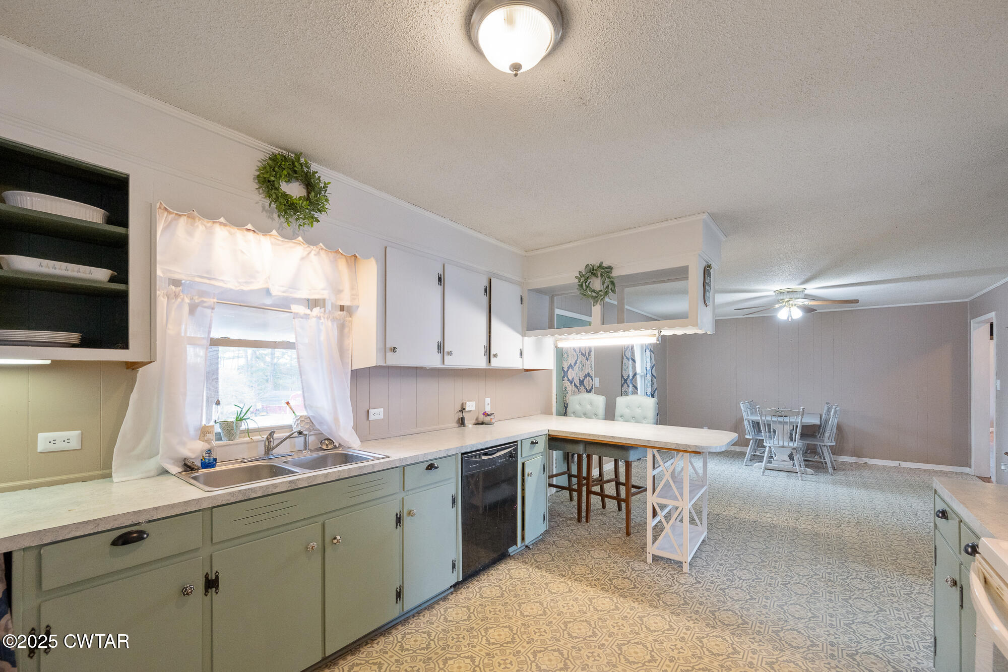 725 East Poplar Drive Decaturville, TN 38329 - Photo 12 of 43 a kitchen with a sink cabinets and window