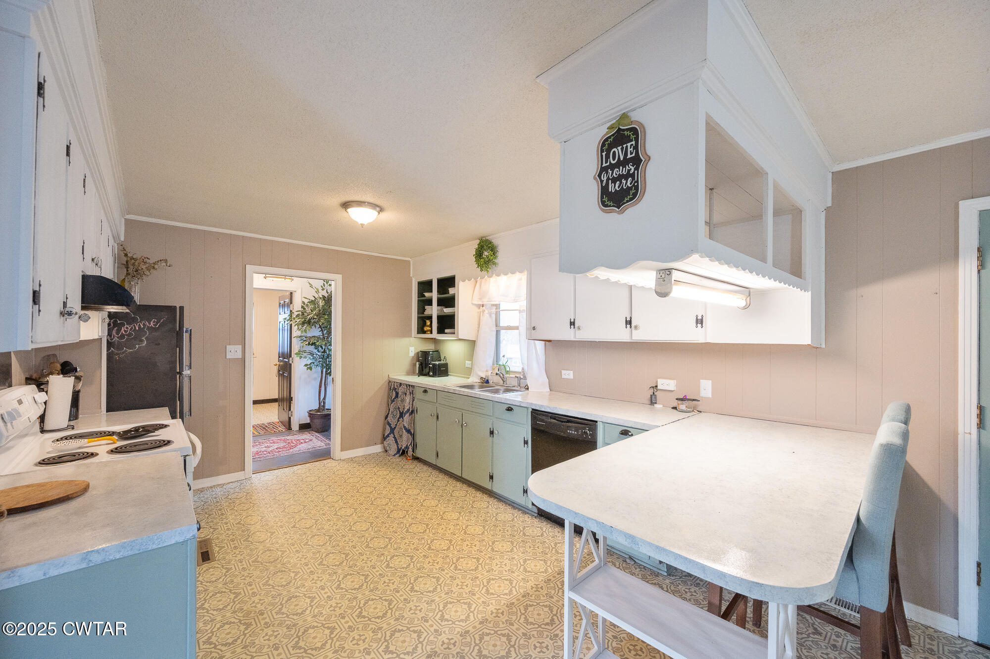 725 East Poplar Drive Decaturville, TN 38329 - Photo 13 of 43 a kitchen that has a sink and a stove in it
