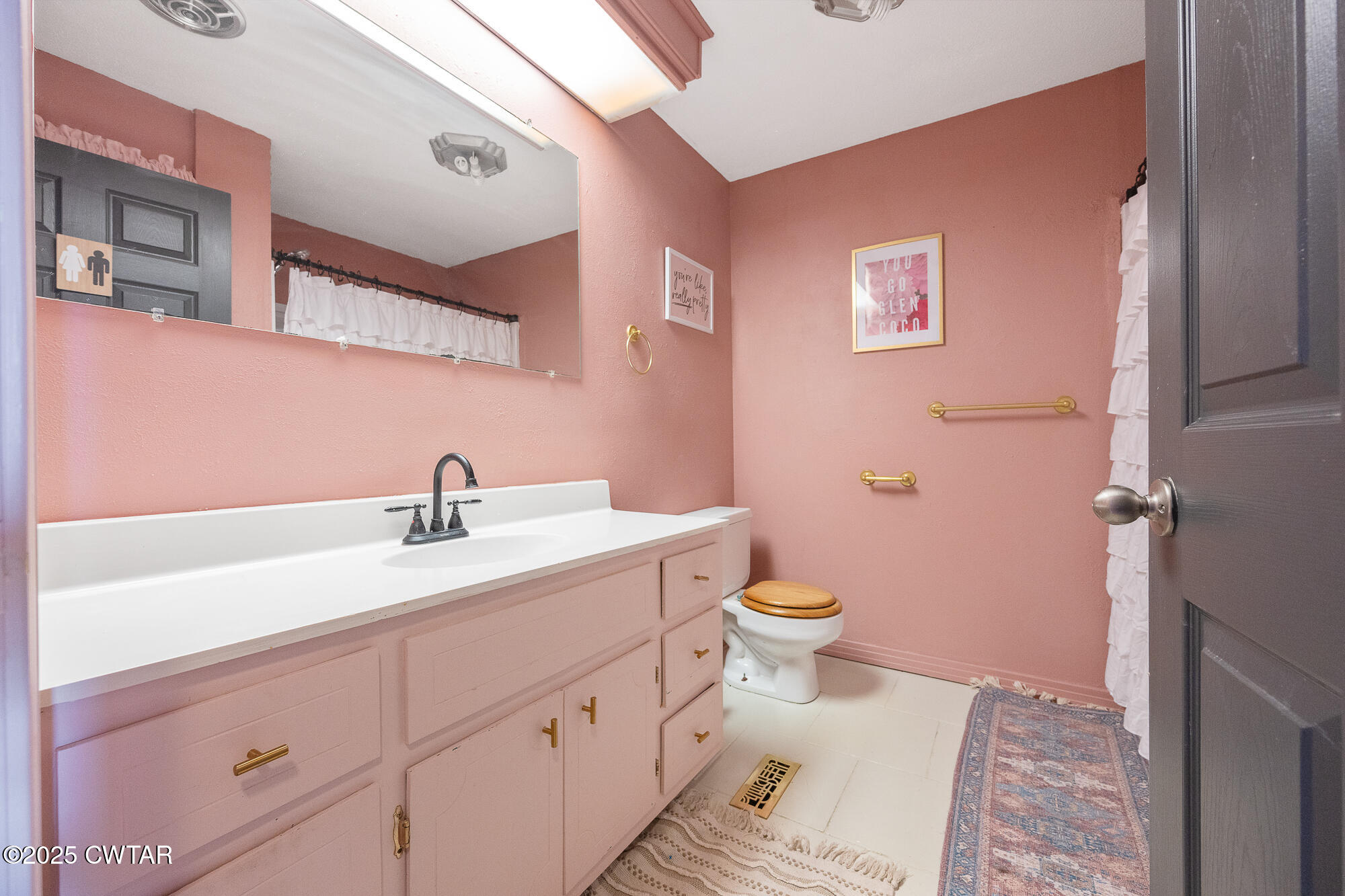 725 East Poplar Drive Decaturville, TN 38329 - Photo 20 of 43 a bathroom with a granite countertop toilet a sink and a mirror