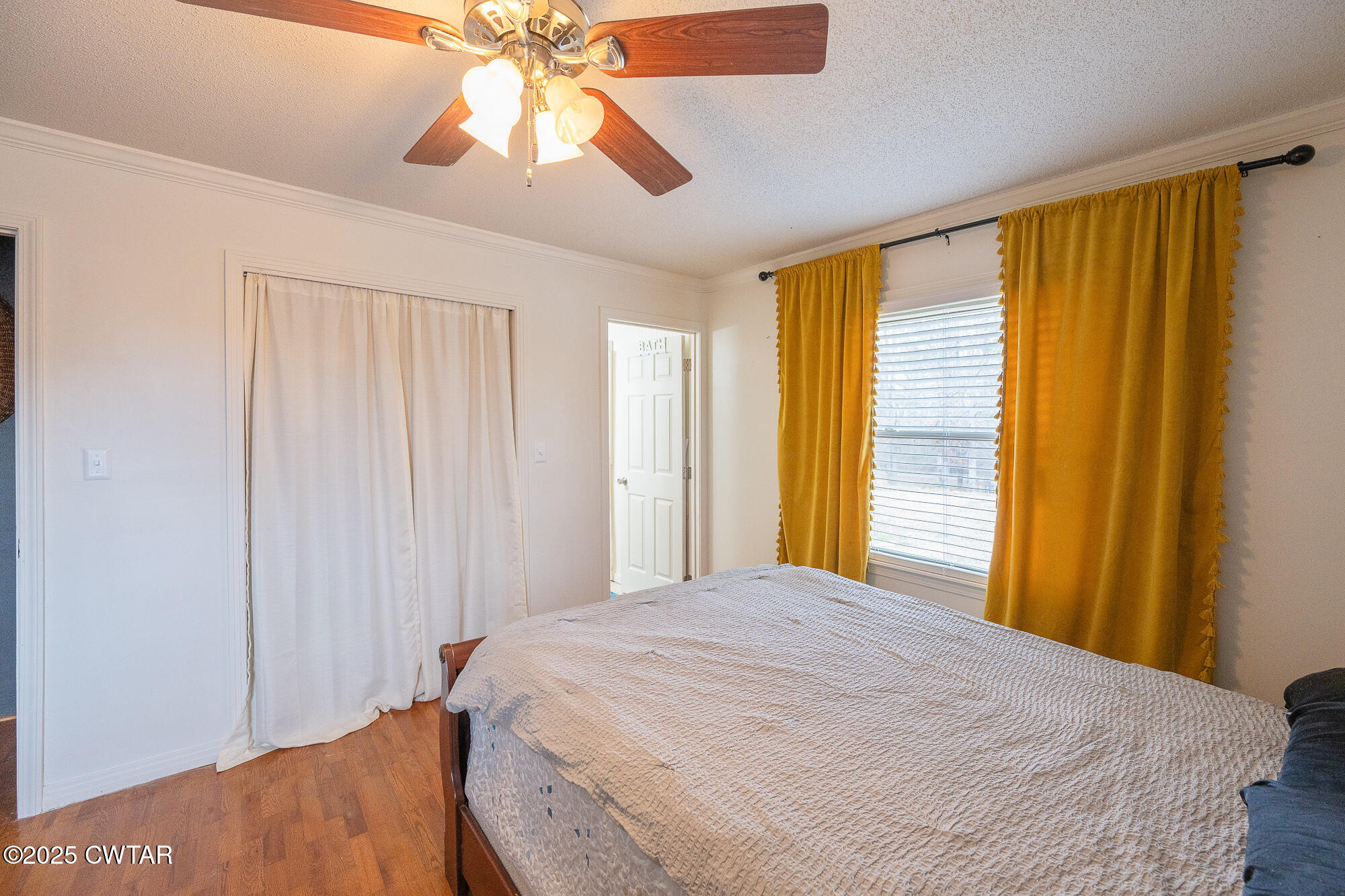 725 East Poplar Drive Decaturville, TN 38329 - Photo 23 of 43 a bedroom with a bed and a chandelier