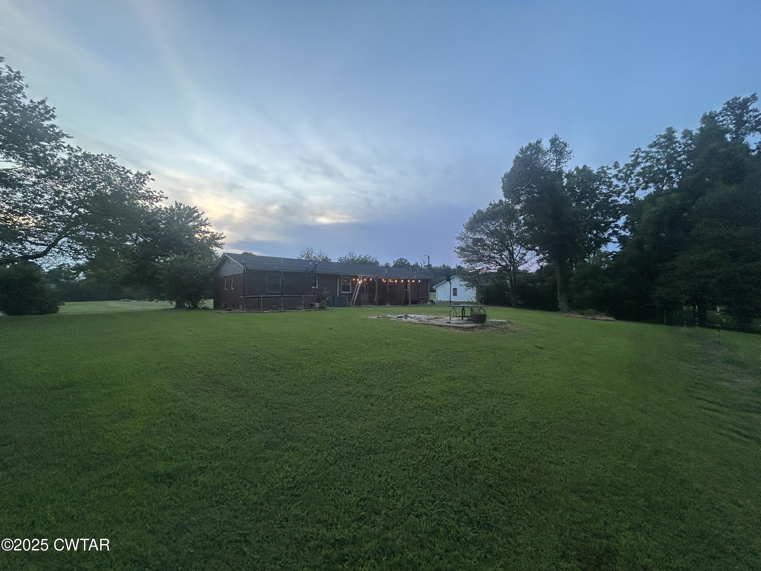 725 East Poplar Drive Decaturville, TN 38329 - Photo 36 of 43 a backyard of a house with lots of green space