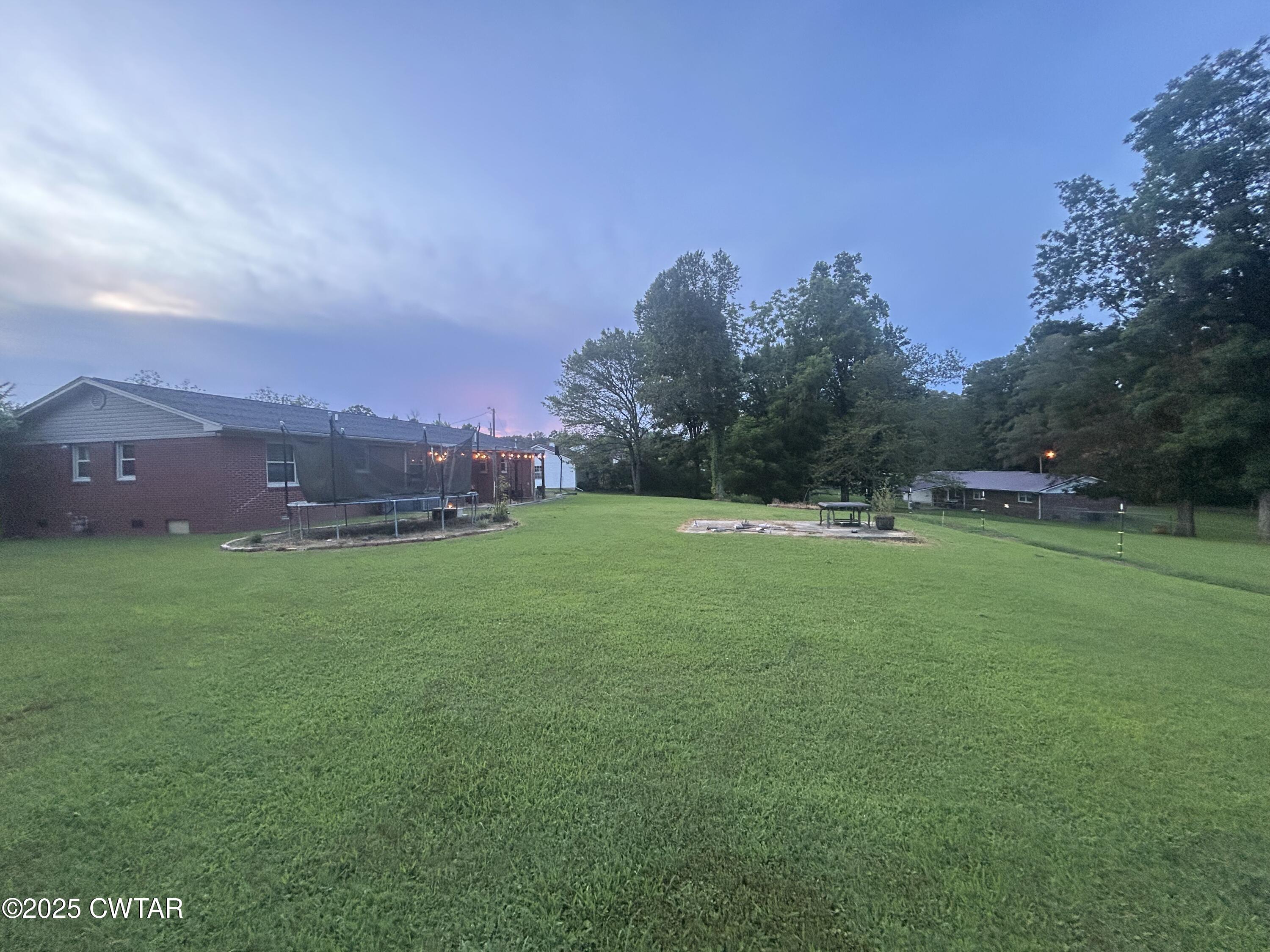 725 East Poplar Drive Decaturville, TN 38329 - Photo 40 of 43 a view of a field of grass and trees