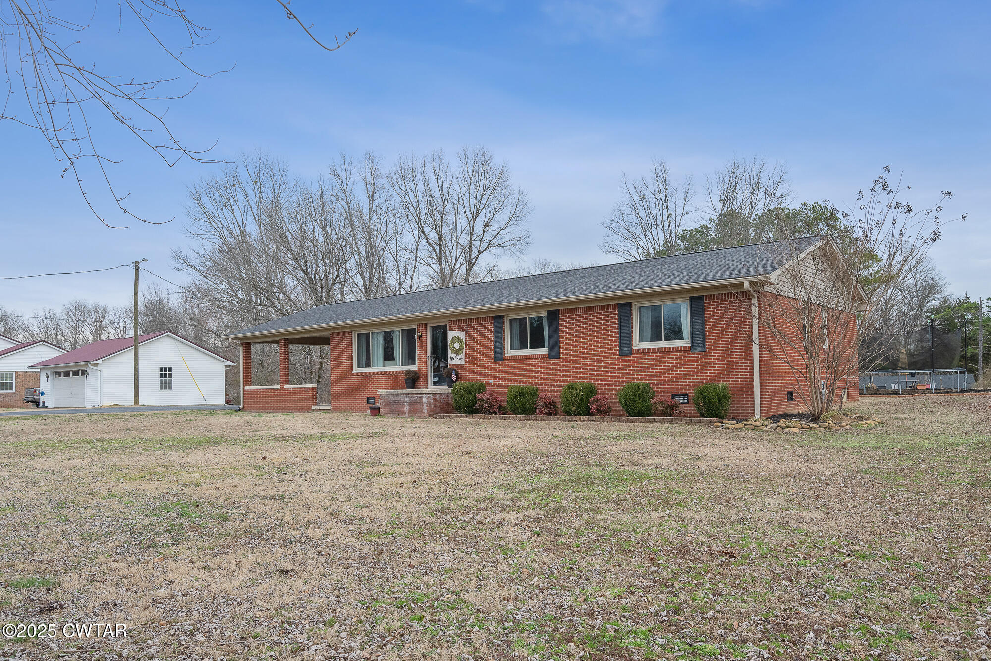 725 East Poplar Drive Decaturville, TN 38329 - Photo 5 of 43 a front view of a house with a yard