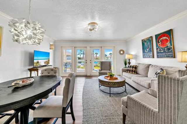 a living room with furniture and a chandelier