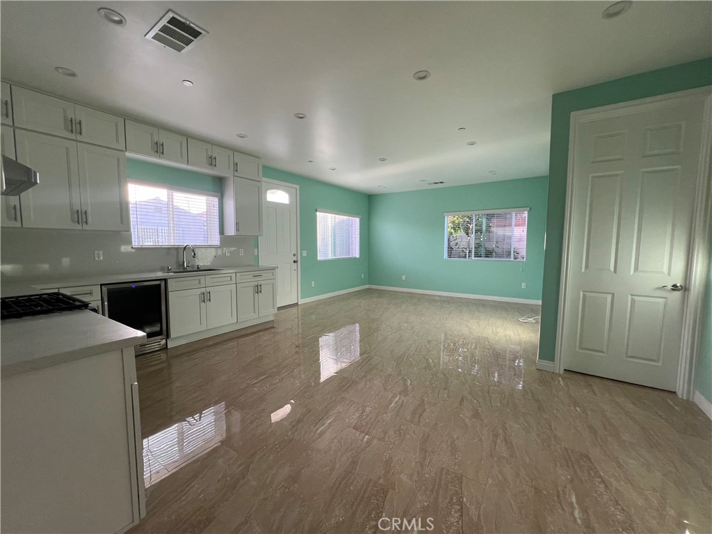 a view of a kitchen with a sink and dishwasher cabinets