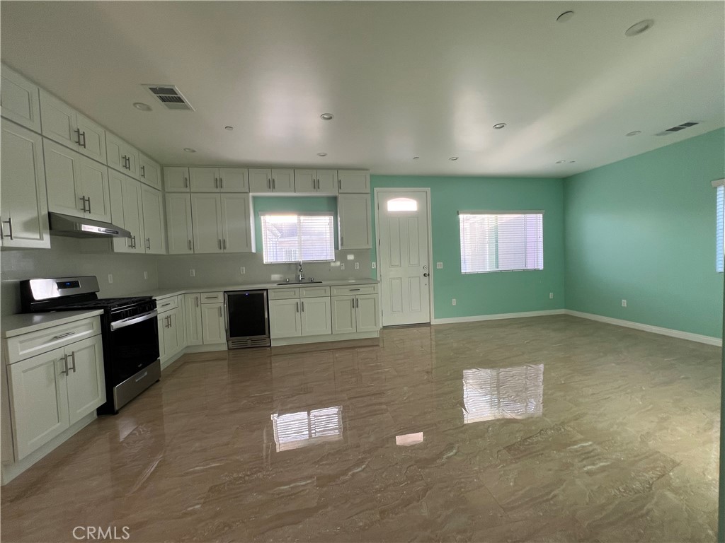714 South 8th Alhambra, CA 91801 - Photo 3 of 7 a kitchen with stainless steel appliances granite countertop a stove a sink and a refrigerator