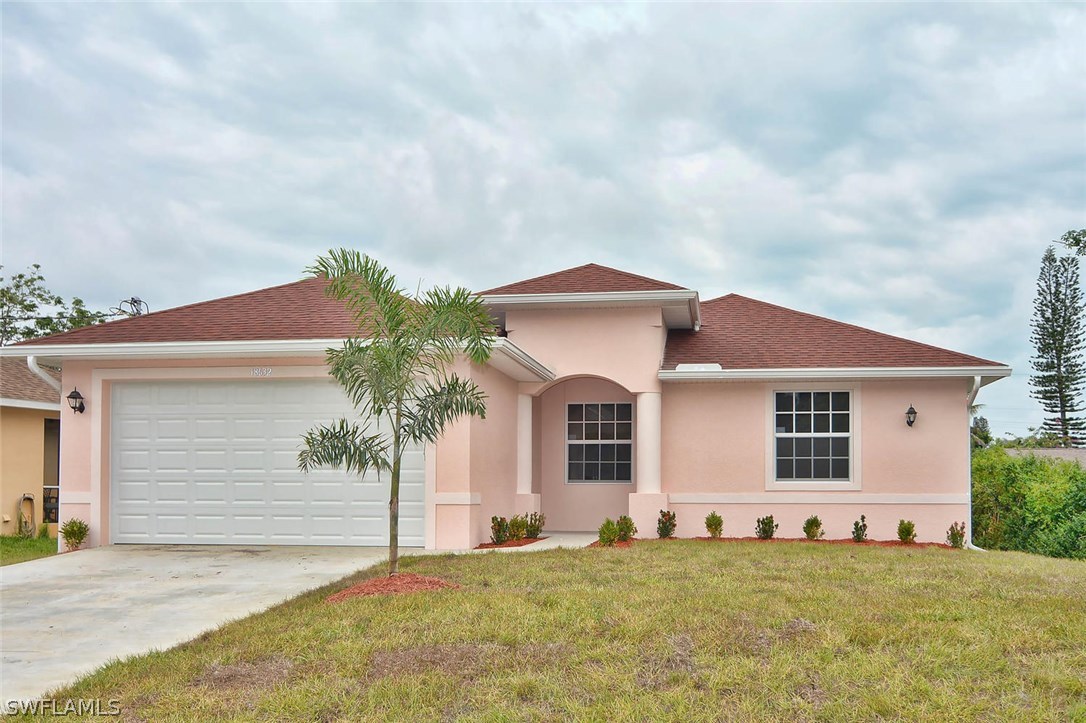 18632 Holly Road Fort Myers, FL 33967 - Photo 1 of 16 a front view of a house with a yard and garage