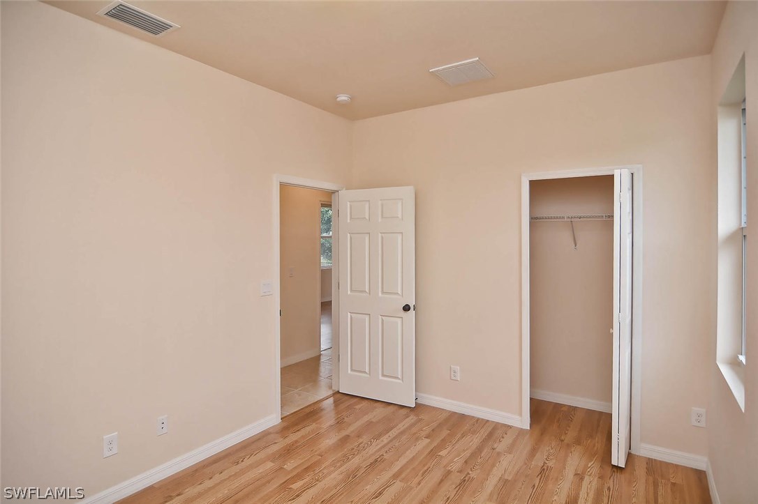 18632 Holly Road Fort Myers, FL 33967 - Photo 14 of 16 a view of an empty room with wooden floor