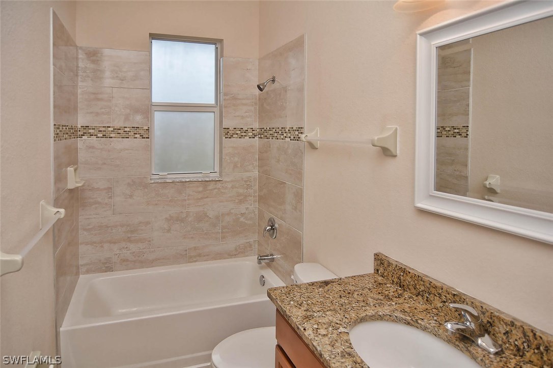 18632 Holly Road Fort Myers, FL 33967 - Photo 16 of 16 a bathroom with a granite countertop sink and a mirror