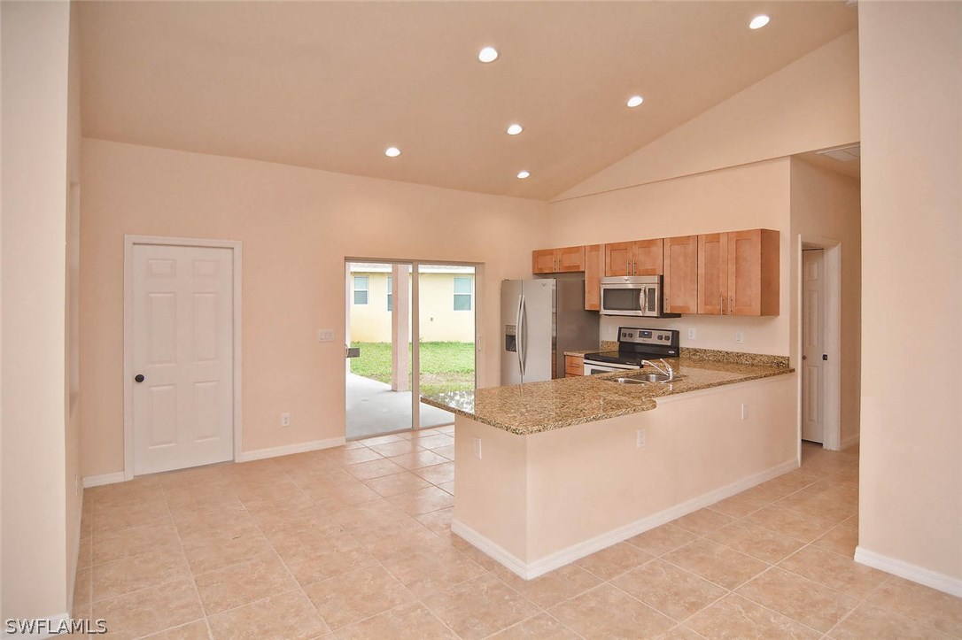 18632 Holly Road Fort Myers, FL 33967 - Photo 3 of 16 a large white kitchen with a large window