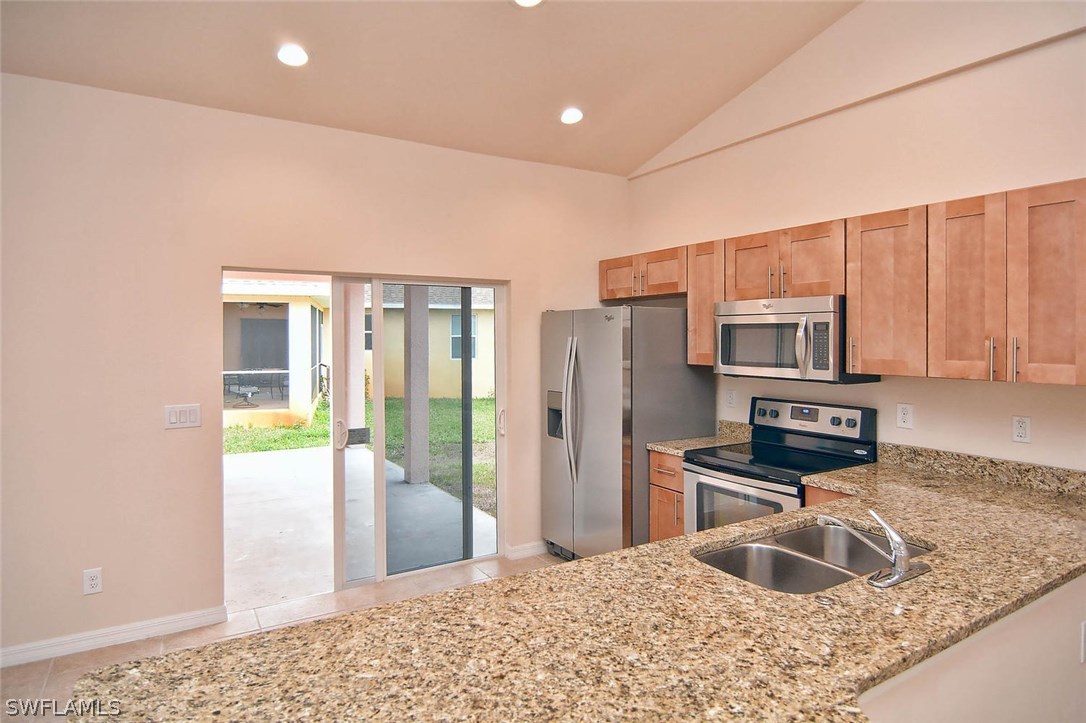 18632 Holly Road Fort Myers, FL 33967 - Photo 7 of 16 a kitchen with refrigerator and countertop