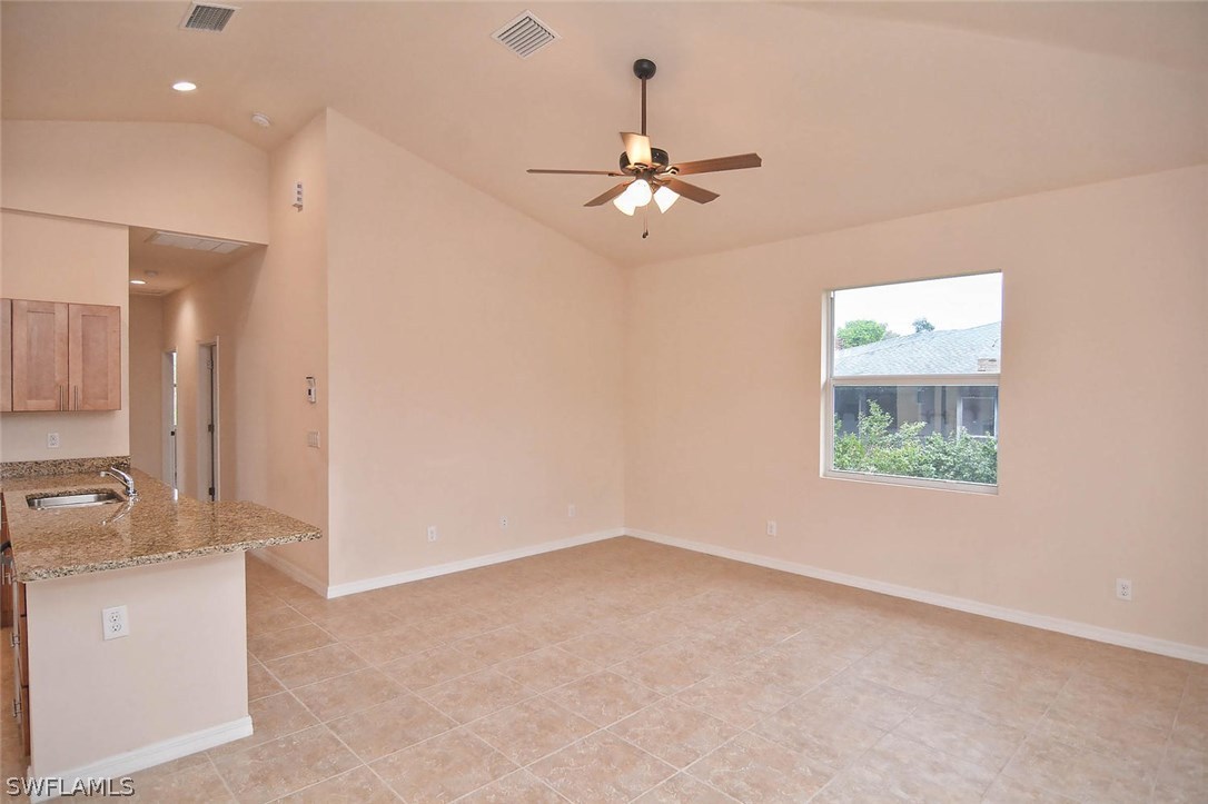 18632 Holly Road Fort Myers, FL 33967 - Photo 8 of 16 en empty room with windows and ceiling fan