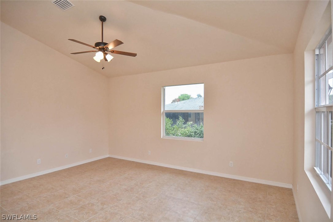 18632 Holly Road Fort Myers, FL 33967 - Photo 9 of 16 an empty room with a window and a fan