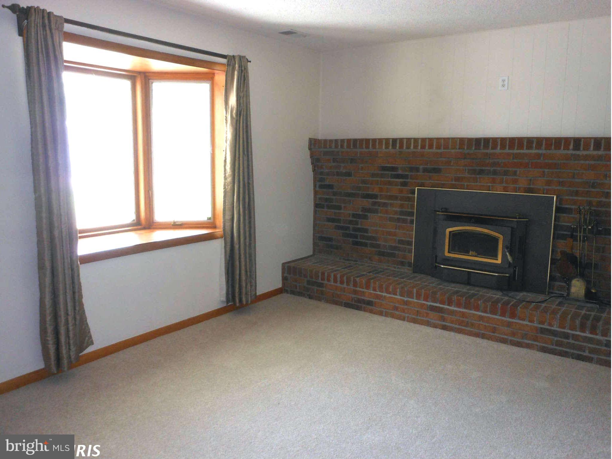 3717 Longley Road Abingdon, MD 21009 - Photo 3 of 22 a view of empty room with window and fireplace