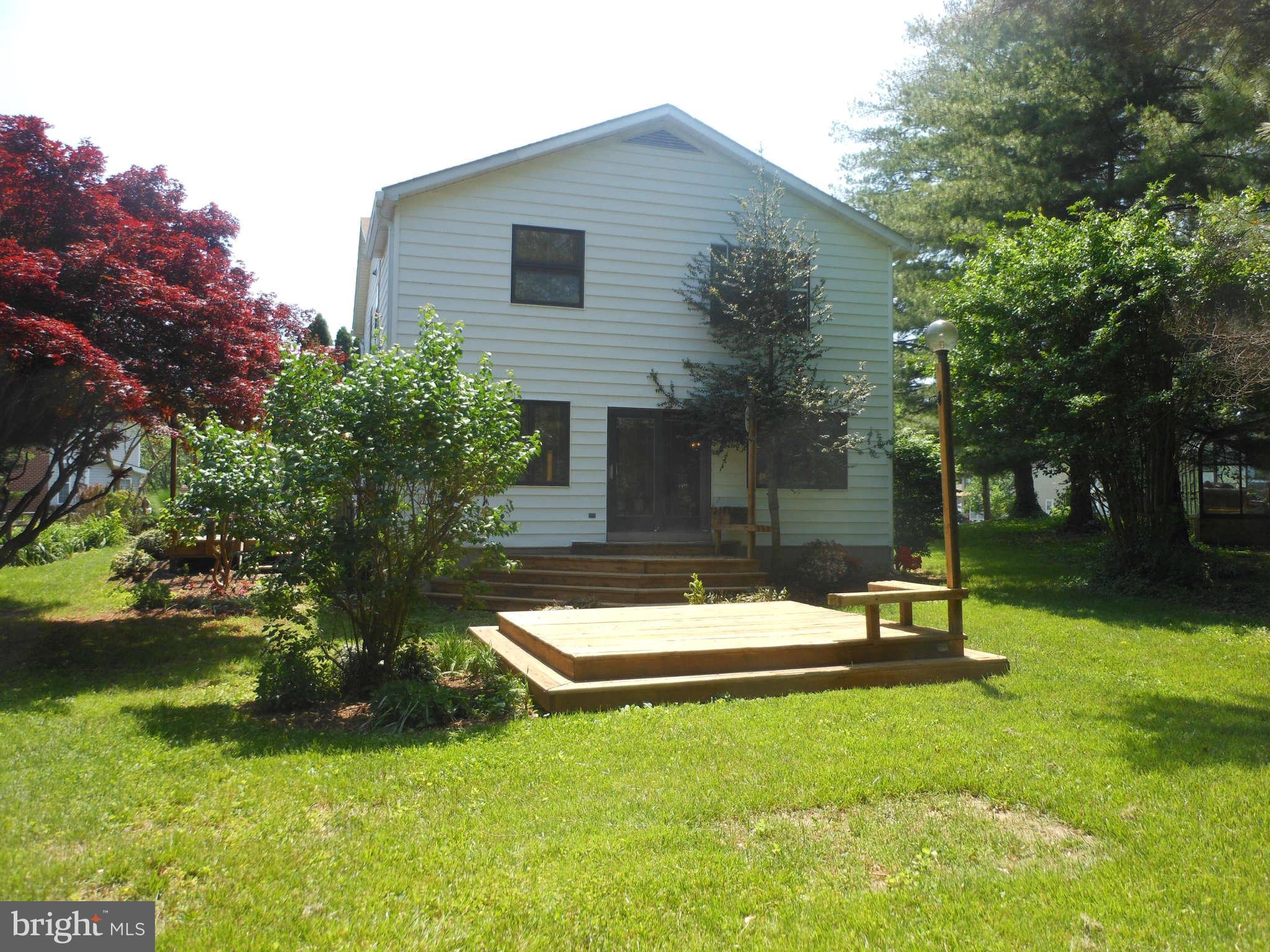 3717 Longley Road Abingdon, MD 21009 - Photo 22 of 22 a backyard of a house with table and chairs plants and large tree