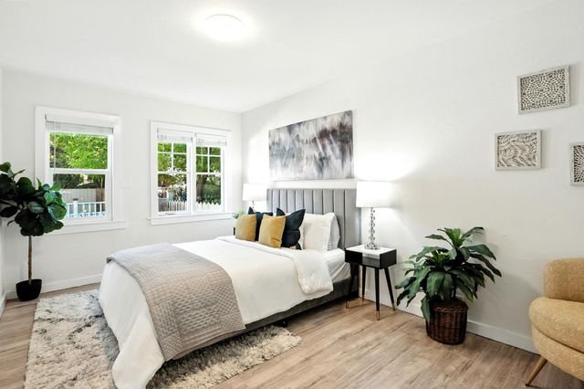 a bedroom with a bed table and a couch