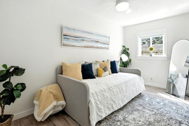 a bedroom with bed and a potted plant