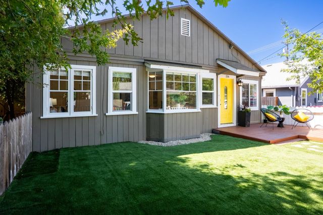 a view of a house with a yard and sitting area