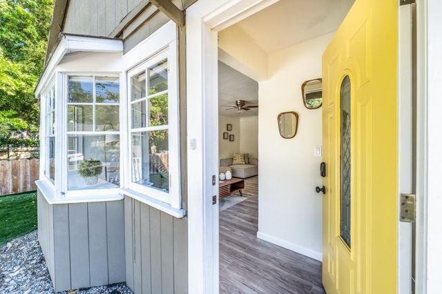 a view of a door and wooden floor in front of a house