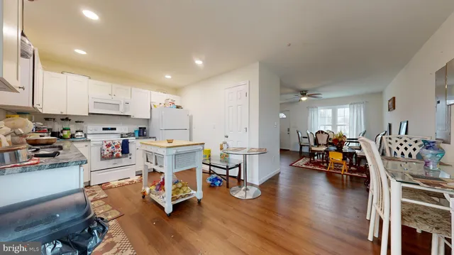 a kitchen that has a lot of cabinets a sink and appliances