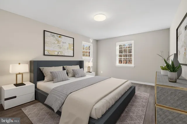 a bedroom with bed and a potted plant