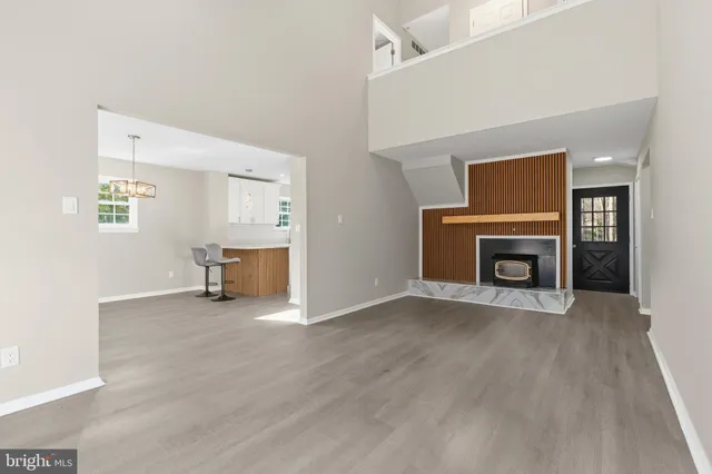 an empty room with furniture and a fireplace