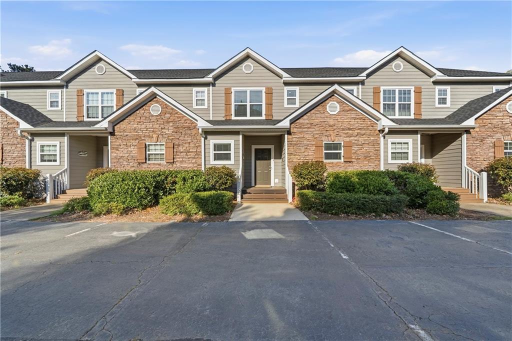 549 Old Phoenix Road Northeast, Unit 104 Eatonton, GA 31024 - Photo 5 of 48 front view of a house with a yard