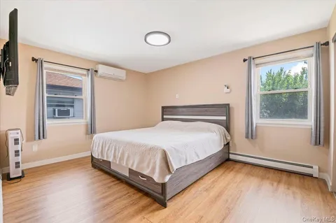 a bathroom with a sink a toilet a mirror and shower