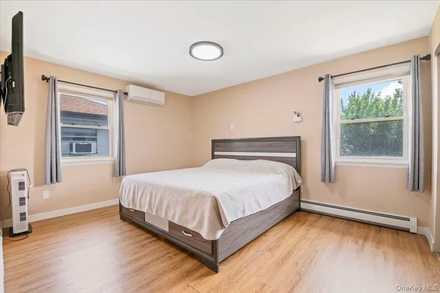 a bathroom with a sink a toilet a mirror and shower