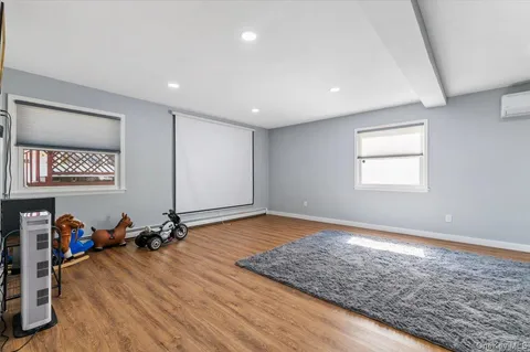 a view of a room with wooden floor and window