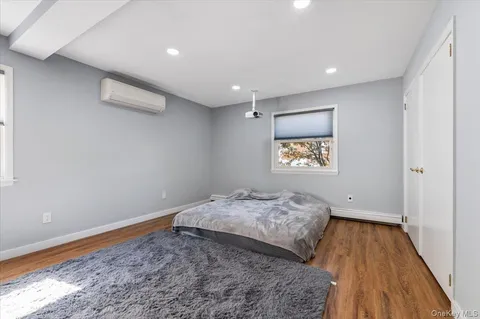 a view of a room with window and hardwood floor