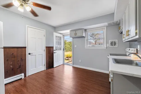 a kitchen with wooden cabinets and white appliances