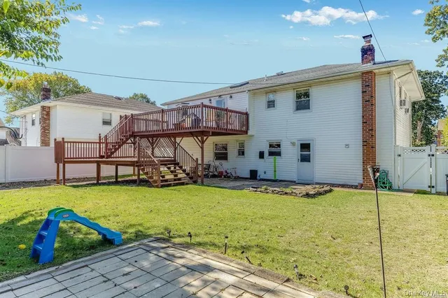 an aerial view of a house with swimming pool and a yard