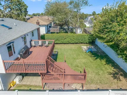 a view of an house with backyard and balcony