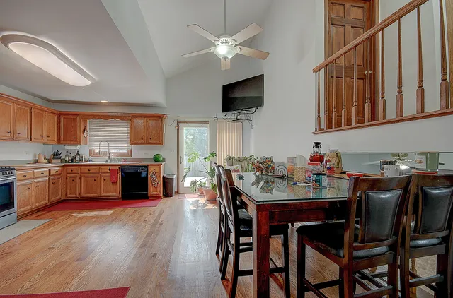 a large kitchen with stainless steel appliances granite countertop a refrigerator stove microwave and sink