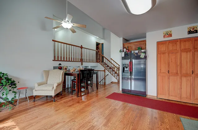 an empty room with windows and fireplace